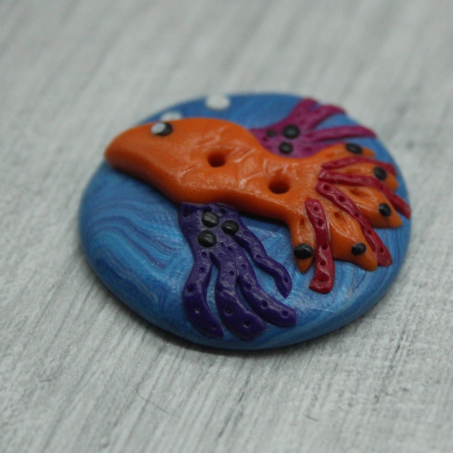Fish polymer clay button