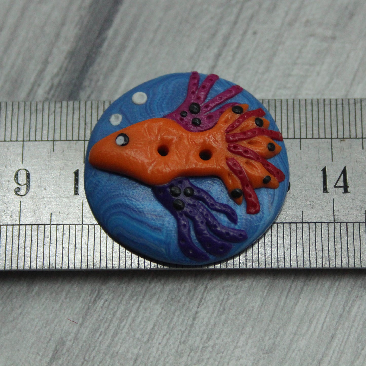 Fish polymer clay button